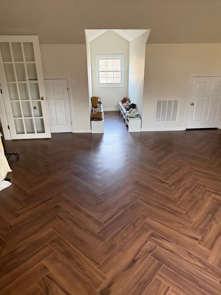 Herringbone hardwood flooring installed by our in-house crew
